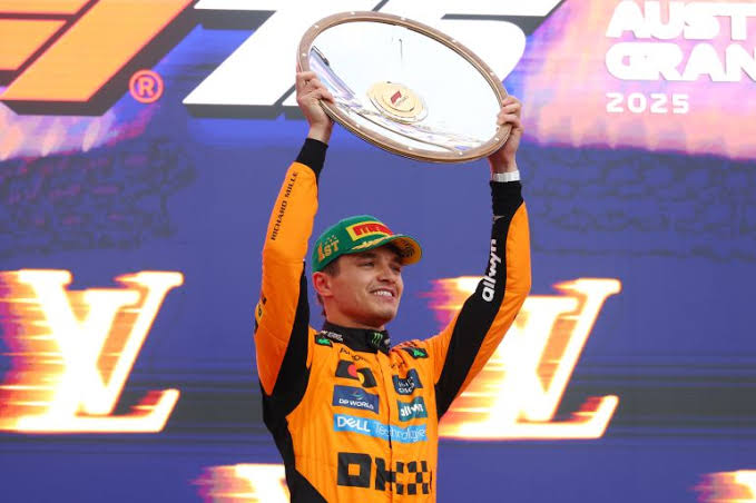 Lando Norris holds up his trophy after winning the 2025 Australian F1 GP